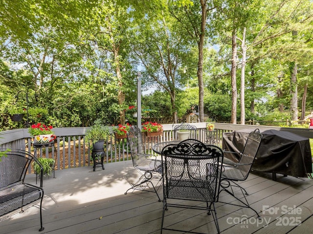 13600 Seastone Ln, Pineville, NC 28134 - wooden deck with outdoor dining space, view of wooded area, and grilling area