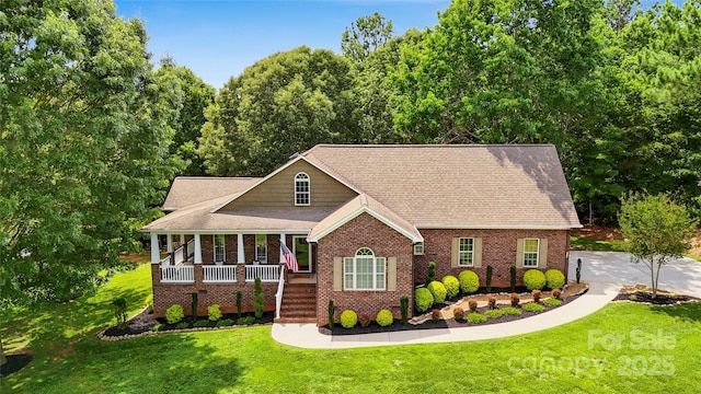 234 Rivercliff Dr, Stony Point, NC 28678 - view of front of home featuring covered porch, a front yard, brick siding, and roof with shingles