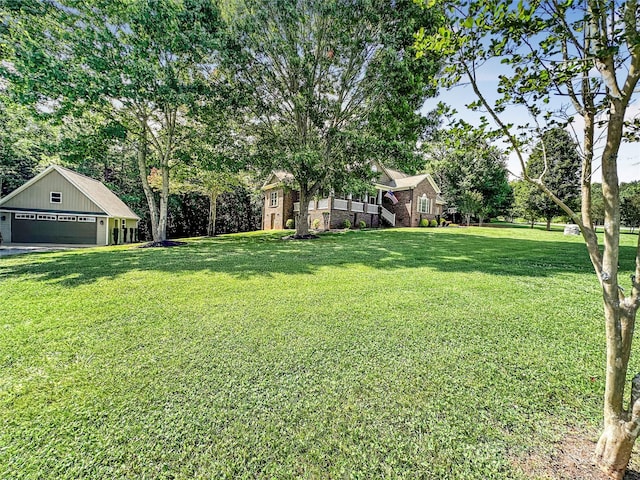 234 Rivercliff Dr, Stony Point, NC 28678 - view of green lawn with a detached garage and view of scattered trees