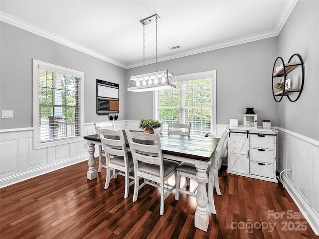 234 Rivercliff Dr, Stony Point, NC 28678 - dining space with healthy amount of natural light, wainscoting, crown molding, dark wood finished floors, and a decorative wall