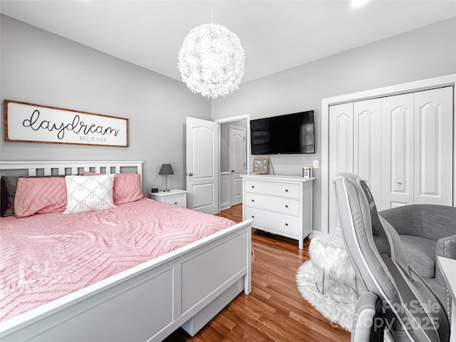 234 Rivercliff Dr, Stony Point, NC 28678 - bedroom featuring wood finished floors, a chandelier, and a closet