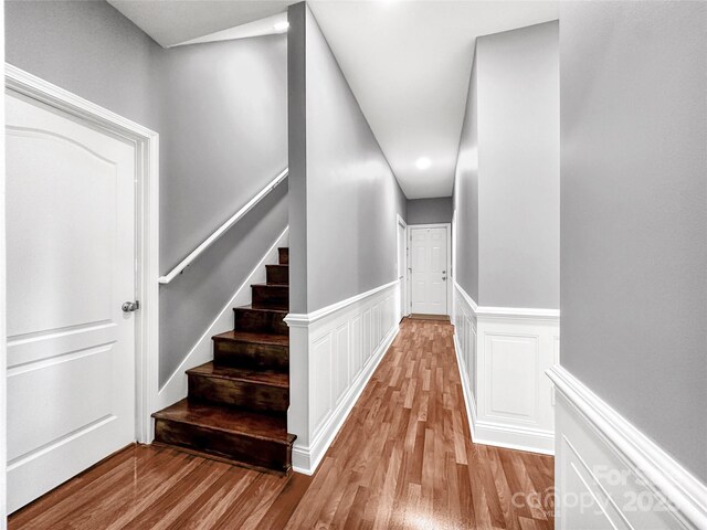 234 Rivercliff Dr, Stony Point, NC 28678 - stairway featuring wood finished floors, a wainscoted wall, and recessed lighting