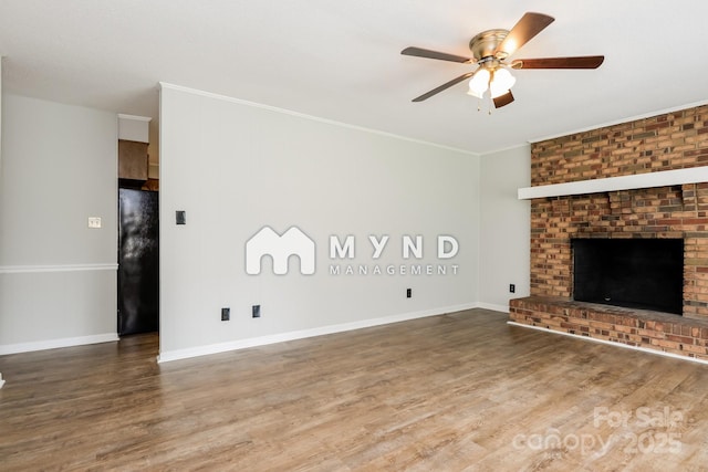 4308 Pinto Ln, Gastonia, NC 28052 - unfurnished living room with ceiling fan, wood finished floors, crown molding, and a fireplace
