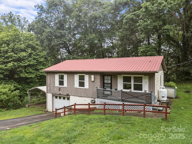 327 Glenwood Dr, Clyde, NC 28721 - single story home with a garage, a front yard, a metal roof, and driveway