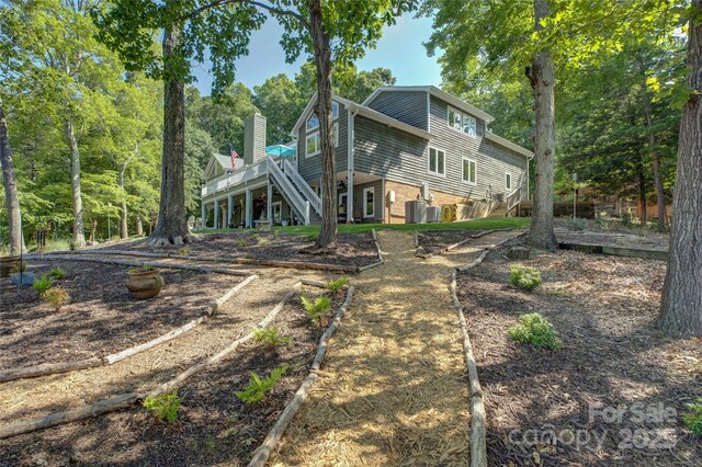 18205 Royal Oak Rd, Charlotte, NC 28278 - rear view of house featuring stairway, a deck, and a chimney