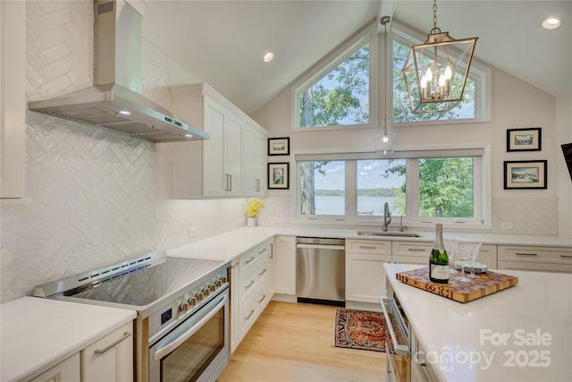 18205 Royal Oak Rd, Charlotte, NC 28278 - kitchen featuring appliances with stainless steel finishes, wall chimney exhaust hood, backsplash, light countertops, and white cabinetry