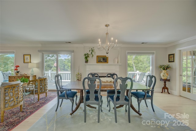 18205 Royal Oak Rd, Charlotte, NC 28278 - dining area featuring light wood-style flooring, crown molding, and a chandelier