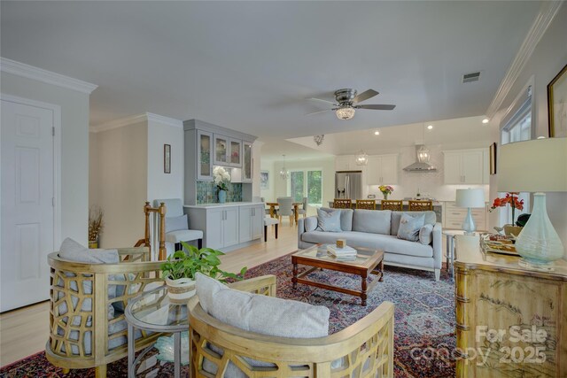 18205 Royal Oak Rd, Charlotte, NC 28278 - living room with ceiling fan, crown molding, light wood-style floors, and recessed lighting