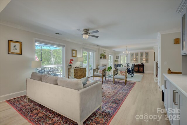 18205 Royal Oak Rd, Charlotte, NC 28278 - living area featuring light wood-style flooring, crown molding, a chandelier, and ceiling fan