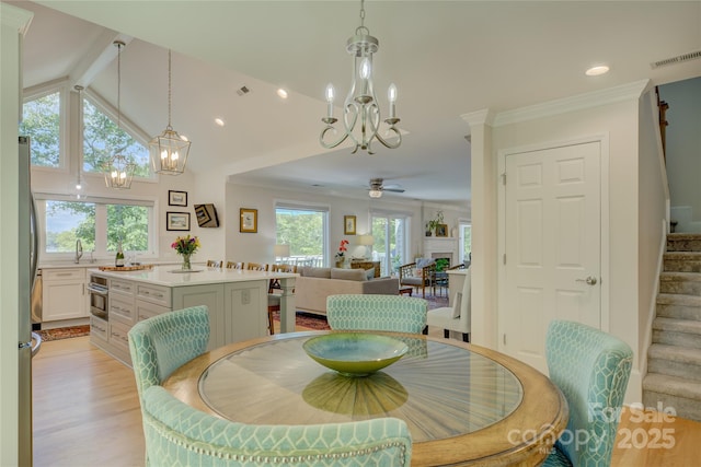 18205 Royal Oak Rd, Charlotte, NC 28278 - dining room with a chandelier, stairway, light wood-type flooring, recessed lighting, and a ceiling fan