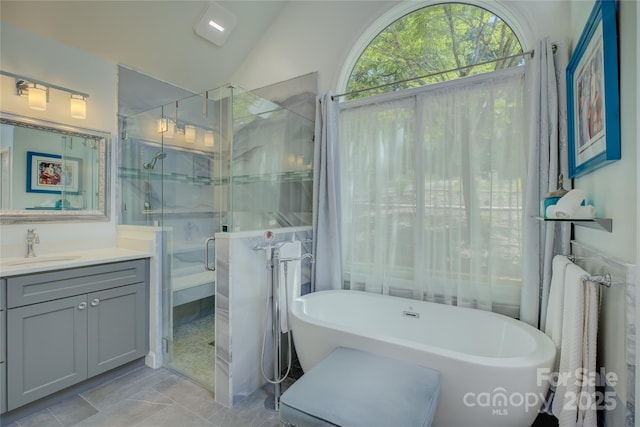 18205 Royal Oak Rd, Charlotte, NC 28278 - bathroom with vanity, a shower stall, a freestanding tub, and vaulted ceiling