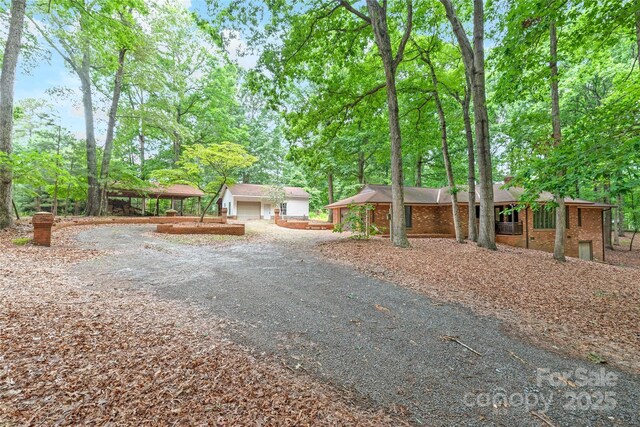 3985 Well Rd, Mint Hill, NC 28227 - view of front of property with brick siding, driveway, and view of wooded area