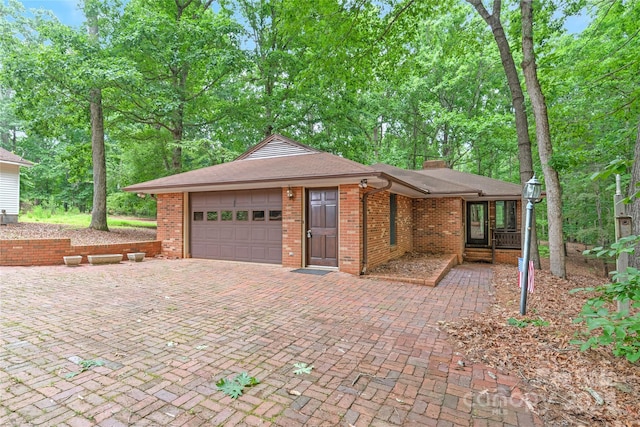 3985 Well Rd, Mint Hill, NC 28227 - view of front of property featuring an attached garage, brick siding, decorative driveway, a chimney, and roof with shingles