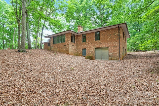 3985 Well Rd, Mint Hill, NC 28227 - rear view of property with a chimney and brick siding