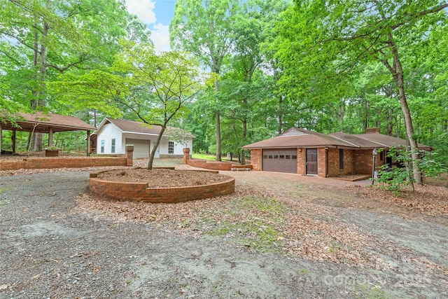 3985 Well Rd, Mint Hill, NC 28227 - view of side of property featuring a garage, a chimney, and view of scattered trees