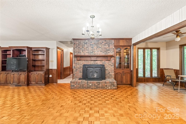 3985 Well Rd, Mint Hill, NC 28227 - living area featuring a textured ceiling, a chandelier, wooden walls, and wainscoting