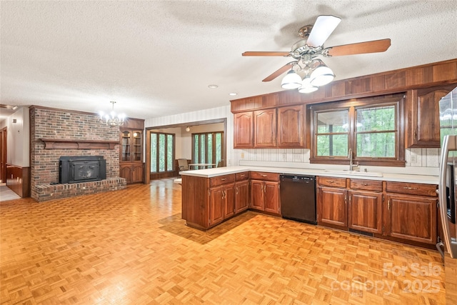 3985 Well Rd, Mint Hill, NC 28227 - kitchen with dishwasher, a sink, a textured ceiling, wooden walls, and a peninsula
