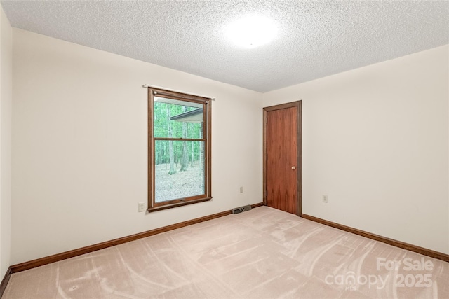 3985 Well Rd, Mint Hill, NC 28227 - unfurnished room with a textured ceiling, light carpet, and baseboards