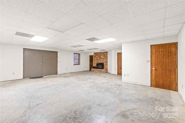 3985 Well Rd, Mint Hill, NC 28227 - unfurnished living room featuring a fireplace, unfinished concrete floors, and a drop ceiling