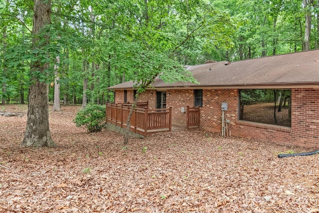 3985 Well Rd, Mint Hill, NC 28227 - back of property with brick siding, a wooden deck, and roof with shingles