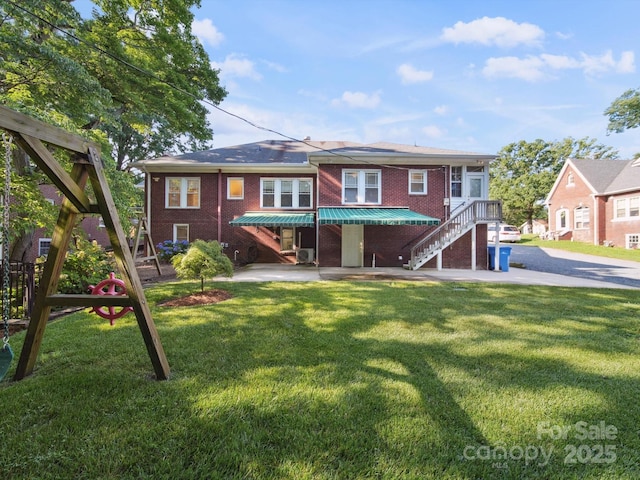 729 Montgomery Ave, Albemarle, NC 28001 - rear view of house featuring brick siding, a yard, and stairway