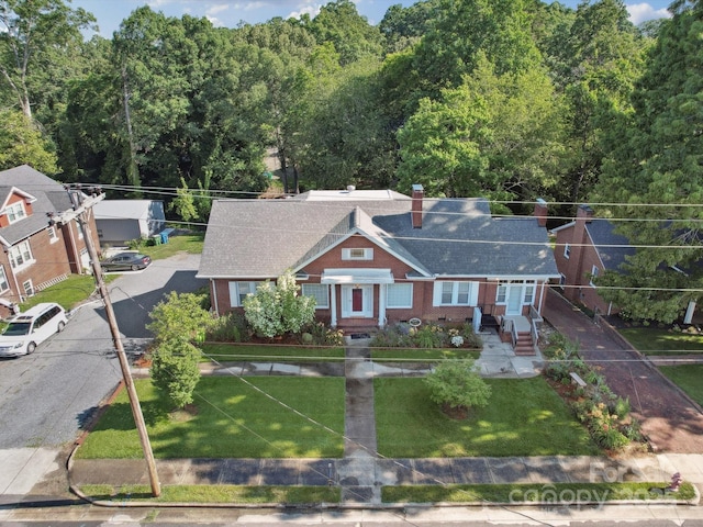 729 Montgomery Ave, Albemarle, NC 28001 - view of front facade featuring a chimney, brick siding, and a front yard