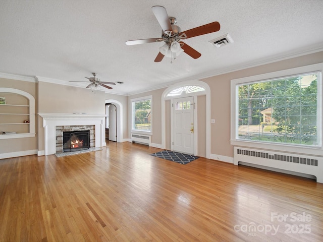 729 Montgomery Ave, Albemarle, NC 28001 - unfurnished living room featuring radiator heating unit, a textured ceiling, plenty of natural light, ceiling fan, and crown molding