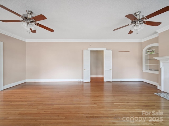 729 Montgomery Ave, Albemarle, NC 28001 - unfurnished living room featuring a ceiling fan, built in shelves, ornamental molding, light wood finished floors, and baseboards