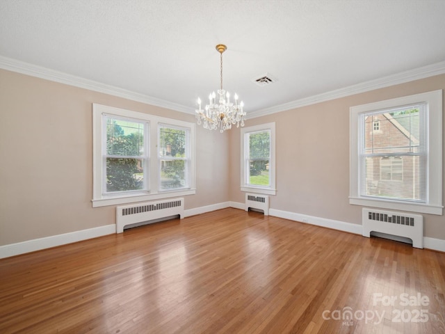 729 Montgomery Ave, Albemarle, NC 28001 - empty room featuring radiator, a chandelier, ornamental molding, and light wood-style flooring