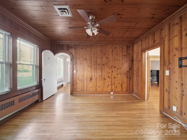 729 Montgomery Ave, Albemarle, NC 28001 - spare room with radiator heating unit, crown molding, arched walkways, a ceiling fan, and wooden ceiling