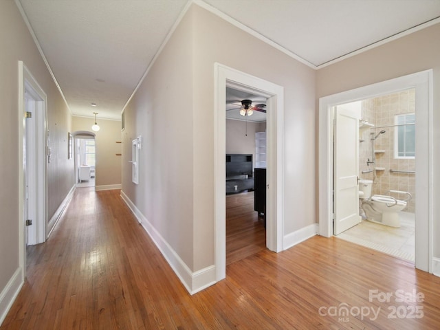 729 Montgomery Ave, Albemarle, NC 28001 - hallway with ornamental molding, wood-type flooring, baseboards, and arched walkways