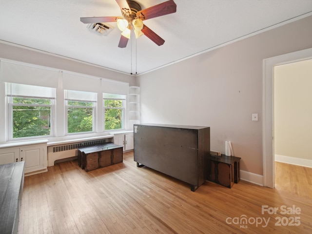 729 Montgomery Ave, Albemarle, NC 28001 - bedroom featuring radiator heating unit, light wood finished floors, ceiling fan, and baseboards