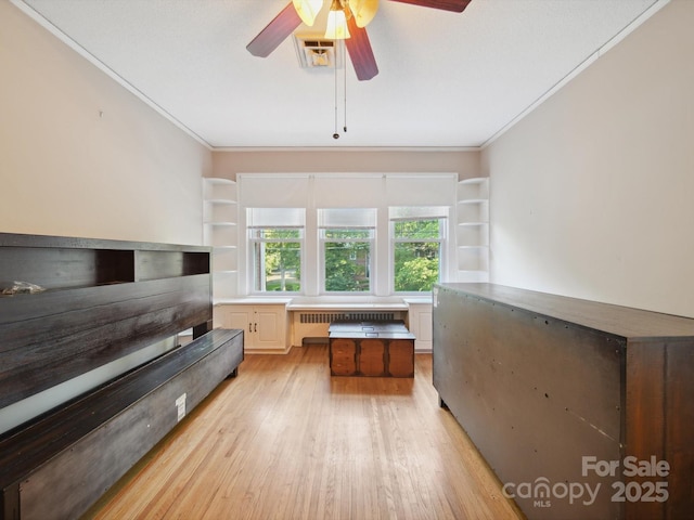 729 Montgomery Ave, Albemarle, NC 28001 - bedroom with crown molding, light wood finished floors, radiator, and ceiling fan