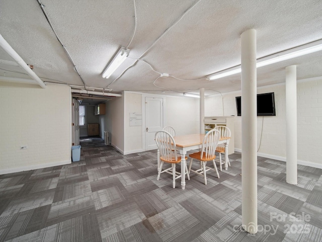 729 Montgomery Ave, Albemarle, NC 28001 - dining area with carpet floors, a textured ceiling, and baseboards