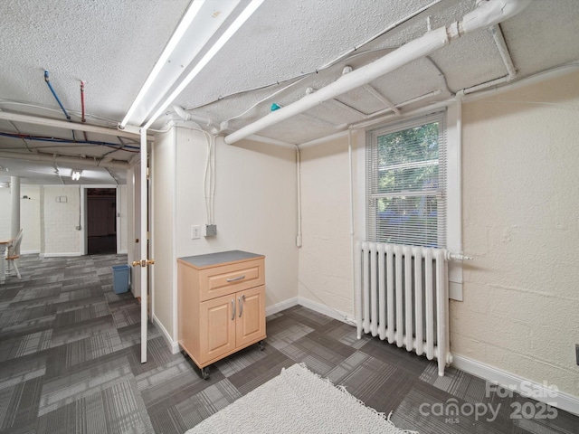 729 Montgomery Ave, Albemarle, NC 28001 - basement with radiator, dark colored carpet, and baseboards