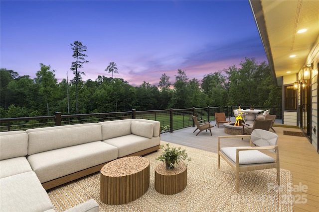 231 Bible School Rd, Lake Lure, NC 28746 - deck at dusk with an outdoor living space with a fire pit