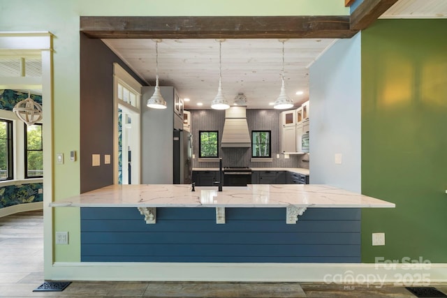 231 Bible School Rd, Lake Lure, NC 28746 - kitchen with a peninsula, a breakfast bar area, stainless steel appliances, custom exhaust hood, and glass insert cabinets