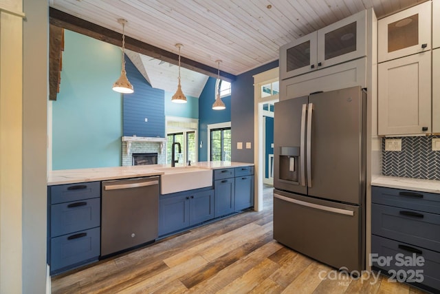 231 Bible School Rd, Lake Lure, NC 28746 - kitchen featuring appliances with stainless steel finishes, a sink, light wood-style flooring, decorative backsplash, and wood ceiling with exposed beams
