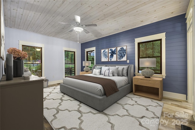 231 Bible School Rd, Lake Lure, NC 28746 - bedroom with wood finished floors, baseboards, ceiling fan, and wooden walls