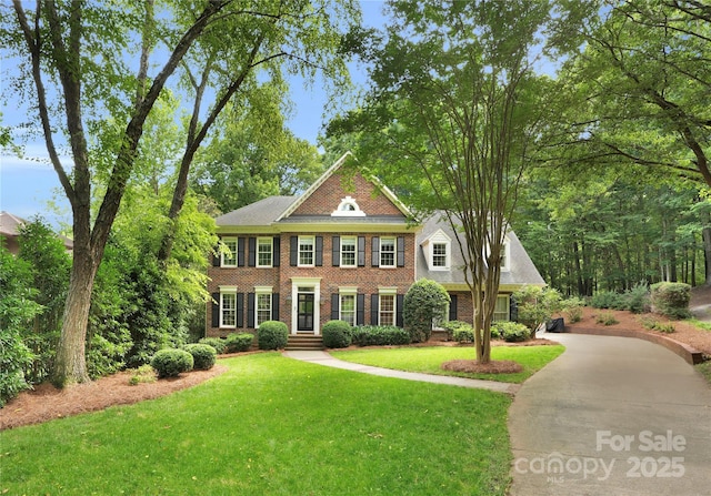 2432 Hartmill Ct, Charlotte, NC 28226 - colonial house with brick siding, a front yard, and driveway