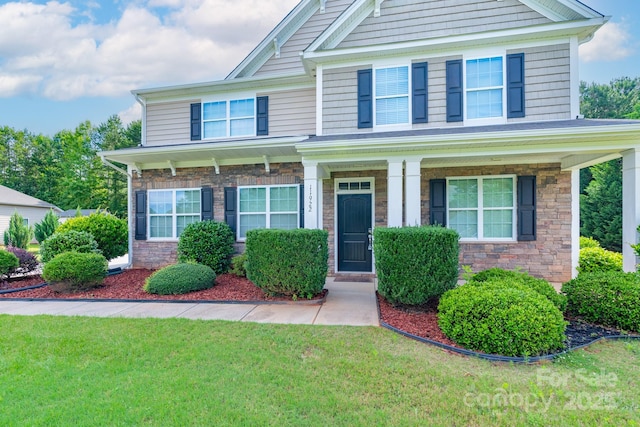 11922 Kimberfield Rd, Matthews, NC 28105 - craftsman inspired home featuring stone siding, a front yard, and a porch