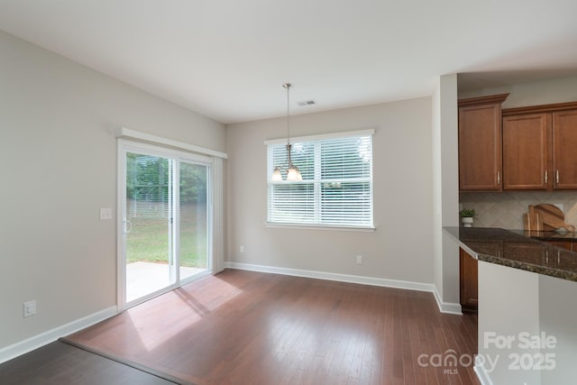 11922 Kimberfield Rd, Matthews, NC 28105 - unfurnished dining area with dark wood-type flooring and baseboards