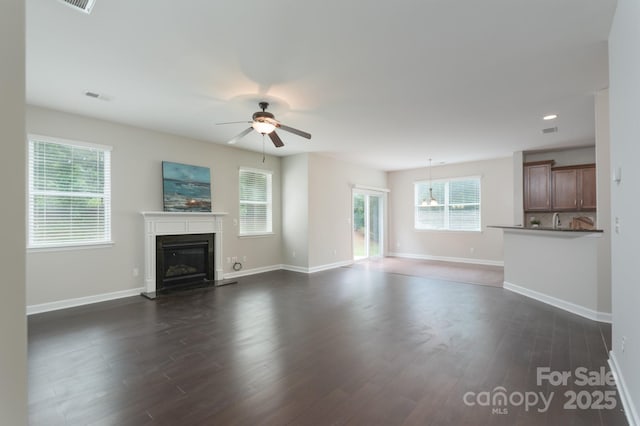 11922 Kimberfield Rd, Matthews, NC 28105 - unfurnished living room featuring a glass covered fireplace, a ceiling fan, dark wood-style flooring, and recessed lighting