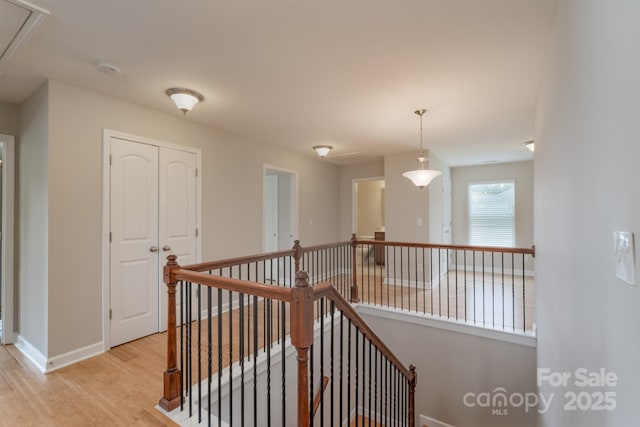 11922 Kimberfield Rd, Matthews, NC 28105 - hall with an upstairs landing, attic access, and light wood finished floors