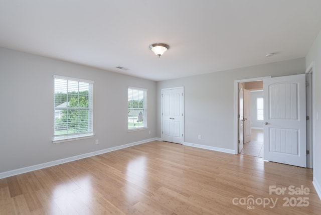 11922 Kimberfield Rd, Matthews, NC 28105 - unfurnished room featuring healthy amount of natural light and light wood-style flooring