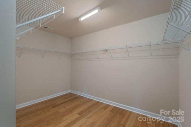11922 Kimberfield Rd, Matthews, NC 28105 - walk in closet with light wood finished floors