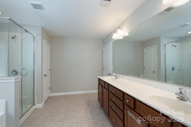 11922 Kimberfield Rd, Matthews, NC 28105 - bathroom with double vanity, a shower stall, tile patterned flooring, and a tub to relax in