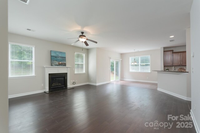 11922 Kimberfield Rd, Matthews, NC 28105 - unfurnished living room featuring a glass covered fireplace, a ceiling fan, dark wood-style floors, and recessed lighting
