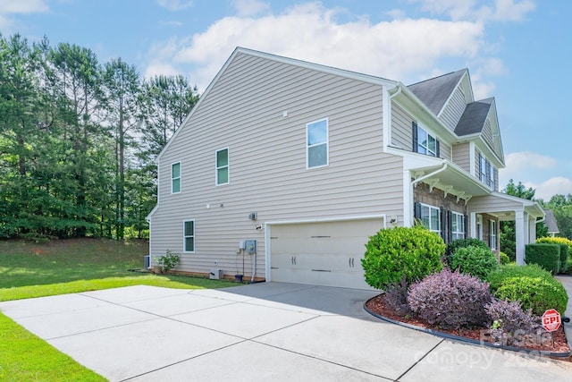 11922 Kimberfield Rd, Matthews, NC 28105 - view of side of property featuring an attached garage, a lawn, and concrete driveway