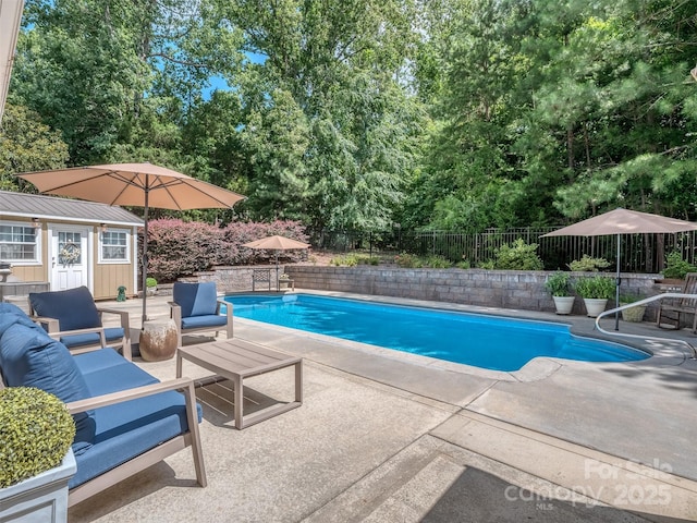 7700 Antique Cir, Waxhaw, NC 28173 - view of pool with a patio area, a fenced backyard, an outdoor living space, an outbuilding, and view of scattered trees